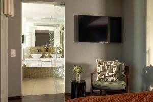 A television and/or entertainment centre at Hotel D - Basel - Fully Renovated 2025