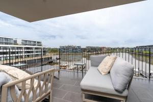 a balcony with a couch and a view of the city at Kingston Foreshore Paradise - 2BR - Hosted by Canstay in Kingston 