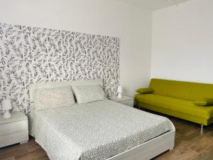 a bedroom with a bed and a green couch at Relais Green Paradise in Apice +45 photos