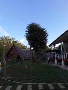 a yard with a tree and a house at Phu Aunna in Ko Phayam