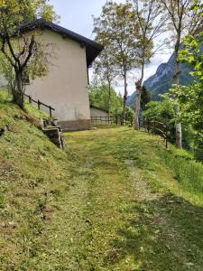 a house on the side of a grassy hill at Azzone Cascina nel verde in Azzone