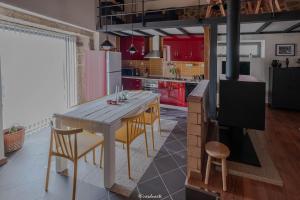 a kitchen with a wooden table with chairs and a stove at Casa Ti Maria in Sorval