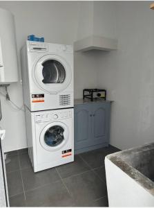 a laundry room with a washer and a dryer at Maré Alta - Scenic Seaside Stay with outdoor deck in Vila Franca do Campo +14 photos