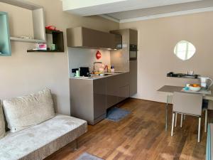 a living room with a couch and a kitchen at Lago Welcome Palais Suite in Clausen