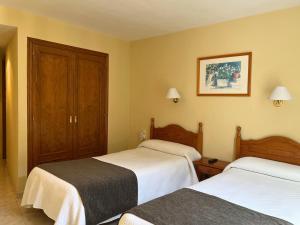 Postel nebo postele na pokoji v ubytování Hotel Juan Canejan