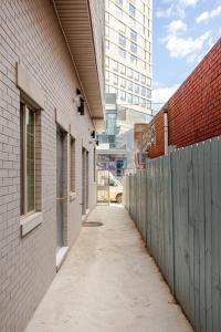 an alley between two buildings with a fence at Cozy Stay Near Fishtown - Close to Subway & Center City! in Philadelphia