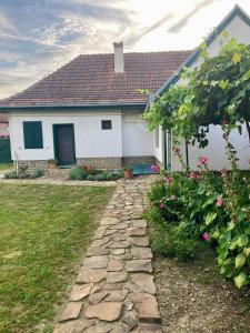 a white house with a stone path in front of it at Casa Veronica in Sibiu