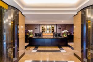 a lobby of a hotel with a reception desk at Sandton Sun and Towers in Johannesburg +37 photos