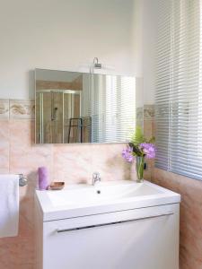 a bathroom with a white sink and a mirror at Casa Ponte Ballerino in Cannobio
