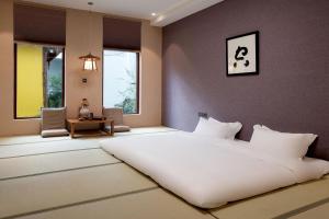 Postel nebo postele na pokoji v ubytování Lijiang Snow Mountain Bengu Hotel-Shuhe Ancient Town Branch 丽江雪山奔鼓酒店-束河古镇店