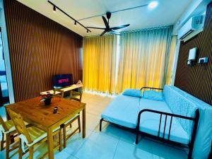 a living room with a couch and a table at Stunning Luxury Breathtaking Sea & City Views 3BR 12PAX in Jelutong