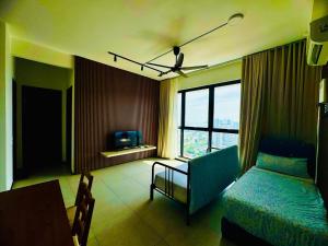 a room with a bed and a couch and a television at Stunning Luxury Breathtaking Sea & City Views 3BR 12PAX in Jelutong