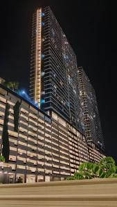 a large building at night with a tall building at Stunning Luxury Breathtaking Sea & City Views 3BR 12PAX in Jelutong