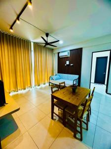 a living room with a table and a bed at Stunning Luxury Breathtaking Sea & City Views 3BR 12PAX in Jelutong