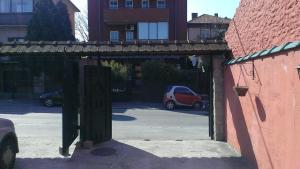 an archway in a parking lot with cars parked at Apartment Akacija Gardens in Belgrade