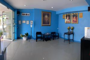 a room with blue walls and tables and chairs at Eco Hostel Hua Hin in Hua Hin