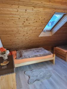 a bedroom with a bed in a wooden cabin at Ferienwohnungen Goldhahn in Eibenstock