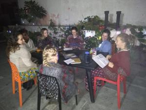 a group of people sitting around a table at The Desire Hostel in New Delhi