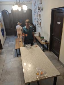 a man and a woman standing in a room with tables at The Desire Hostel in New Delhi