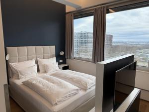 Posteľ alebo postele v izbe v ubytovaní Skyline City Loft