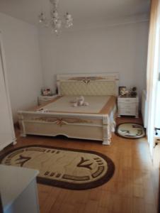 a bedroom with a bed and a rug at Vila Elena in Bucharest