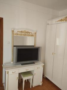 a tv sitting on a dresser in a room at Vila Elena in Bucharest