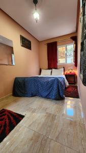 a bedroom with a bed in the corner of a room at Quadra Sphere rooftop in Tamraght Ouzdar
