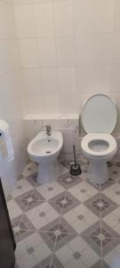 a bathroom with a toilet and a sink at Casa Iris in Iaşi +41 photos