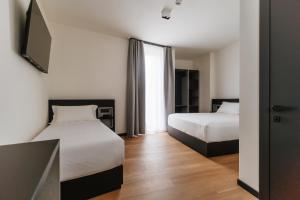 Voodi või voodid majutusasutuse Aspio Hotel toas