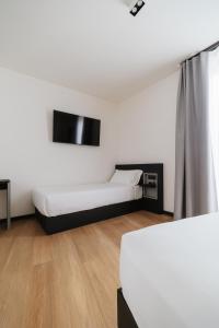 Voodi või voodid majutusasutuse Aspio Hotel toas