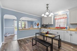 a kitchen with white cabinets and a table at 516 Sweet Cherry Escape in Warrenton