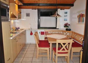 a kitchen with a table and chairs in a kitchen at Ferienhaus Schöps in Burhave