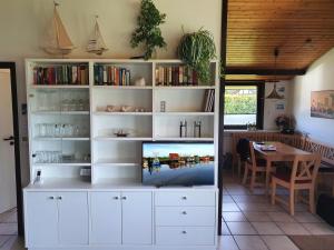 a large white book shelf with a tv on it at Ferienhaus Schöps in Burhave