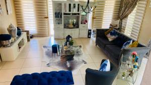 a living room with a couch and a table at Yvee Guesthouse in Hazyview