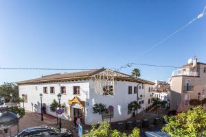 a large white building in a city with buildings at Estudio San Juan in Benalmádena