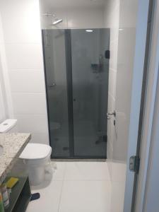 a bathroom with a glass shower with a toilet at Studio super Nova Centro-RJ in Rio de Janeiro