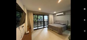 a bedroom with a bed and a large window at Studio super Nova Centro-RJ in Rio de Janeiro +14 photos