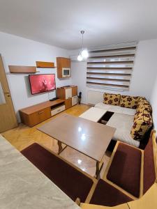 a living room with a couch and a table at Stan na dan Brčko Zaga Uzunovica 5 in Brčko