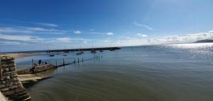 a group of boats in a large body of water at Stunning Harbour View Beachfront Apartment Parking in Rhos-on-Sea