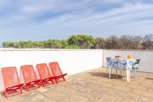 a table and chairs sitting on a patio at Beach Life Apartment In Boncore in Torre Lapillo +26 photos