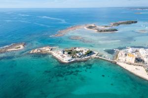 an aerial view of a small island in the ocean at Beach Life Apartment In Boncore in Torre Lapillo