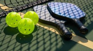 a tennis racket and balls on a tennis court at Truro Sun Lakes in Sun Lakes