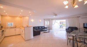 una cucina e un soggiorno con un divano e un tavolo di Spacious 3-bedroom beach Bungalow ad Adeje
