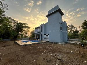 a house with a swimming pool in a yard at Huvazeel Villa - Murbad for Monthly rental only in Saralgaon