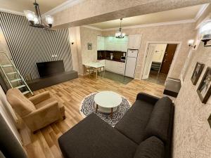 a living room with a couch and a table at Park Azure 0568 in Baku