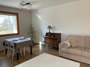 a living room with a table and a couch at Suite Santa Maria in Lovero Valtellino