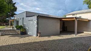 a building with a garage next to a house at La Palombe in Saint-Macaire +2 photos