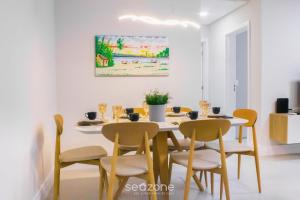 a dining room with a white table and chairs at Modern apartment with barbecue CRR201 in Florianópolis