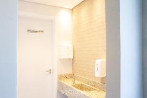a bathroom with a sink and a mirror at Modern apartment with barbecue CRR201 in Florianópolis +30 photos
