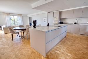 a kitchen with a island with a cat statue on it at Exclusive Villa Magnolia Apartment with Private Pool Cannes Center in Cannes +9 photos
